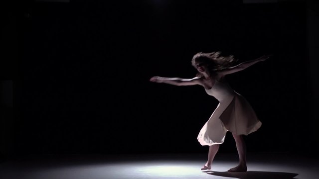 Modern dancer girl in white dress go on dancing contemporary on black, shadow, slow motion