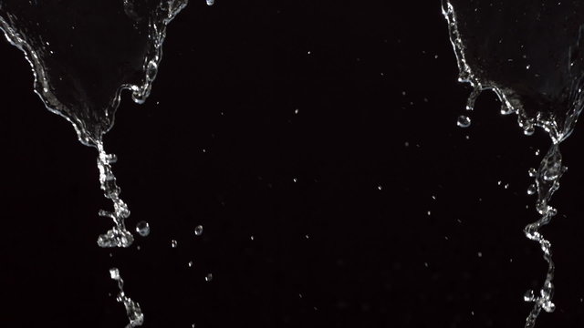Water pouring over black background, slow motion