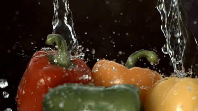 Water pouring over bell peppers