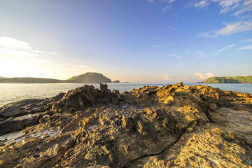 Texture of beach rock with nature sunlight