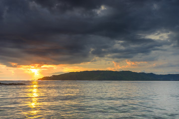 Natural green moss at beach rock with cloudy sunset background