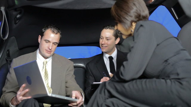 Business people working in limo