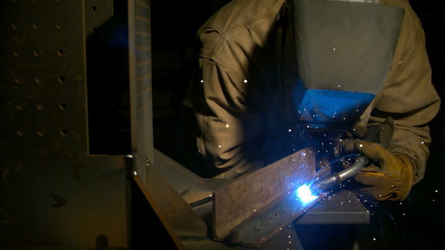 Industrial worker welding, slow motion