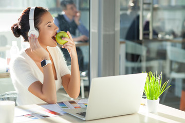 Cute young businesswoman is resting in office