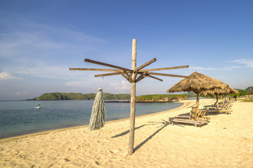 A row of wooden lounge at Lombok beach, Indonesia