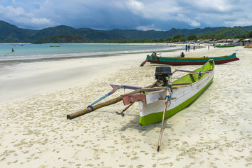 Traditional fisherman wooden boat with cloudy skies at Lombok Selatan, Indonesia