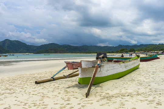 Traditional fisherman wooden boat with cloudy skies at Lombok Selatan, Indonesia