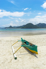 Fototapeta na wymiar Traditional wooden boat park at sea shore with cloudy skies at South Lombok island, Indonesia