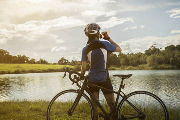 Woman cyclist relaxing drink water from the exercise