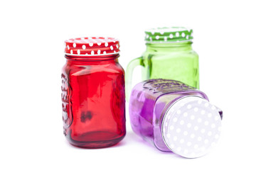 Colourful mason glasses on white background