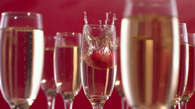 Strawberry splashing into champagne