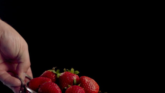 Rinsing strawberries in colander