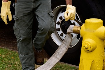 Drain Cleanout / Worker is setting up a drain clean up of the fire hydrant and to fill his truck...