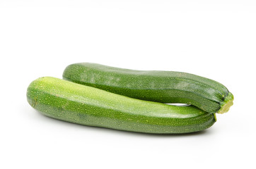 green zucchini on white background
