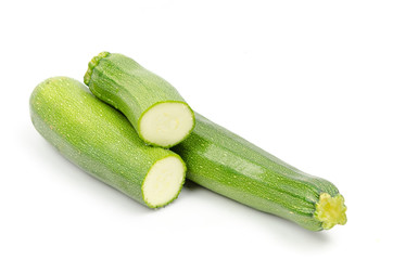 green zucchini on white background