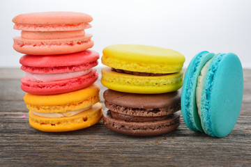 close up of colorful macarons on wooden texture