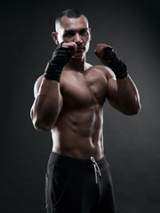 Fototapeta na wymiar Fighter boxer on black background
