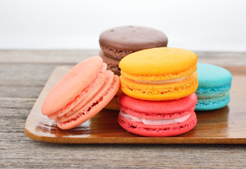 colorful macarons on wooden tray