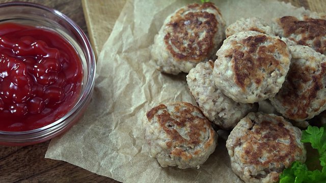 Portion of rotating Mini Burgers (seamless loopable 4K UHD footage)