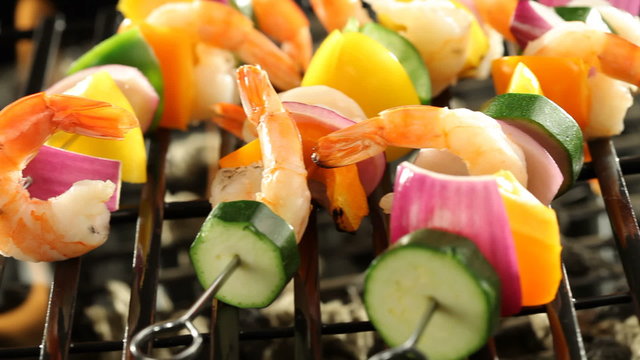 Shrimp and vegetable skewers on barbecue grill