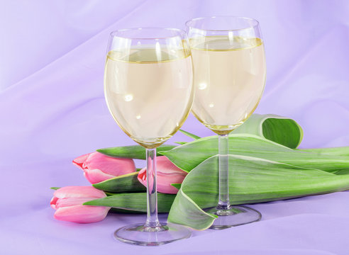 White wine and pink tulip flowers