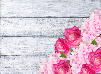Roses and hydrangeas on shabby wooden planks