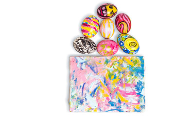 Fototapeta premium Colorful easter egg and small painted canvas on white