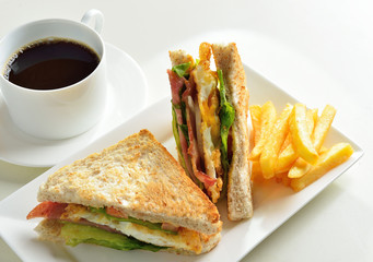 fresh and delicious classic club sandwich and cup of coffee and