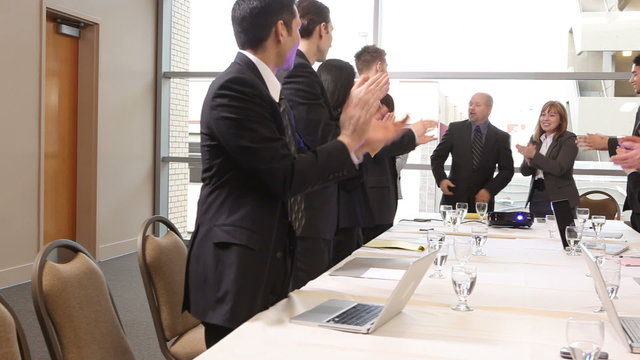 Businesspeople clapping during presentation
