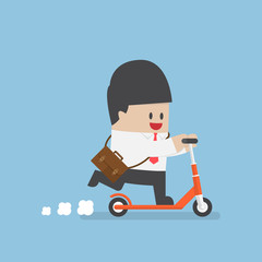 Businessman with briefcase on a kick scooter