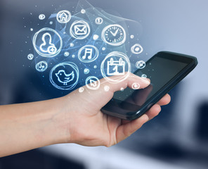 Hand holding smartphone with mobile app choices