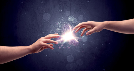 Hands reaching to light a spark