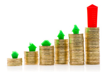 Stacks of coins, green and red home 