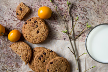 oatmeal cookies on the paper, milk in the glass cup, lemongrass