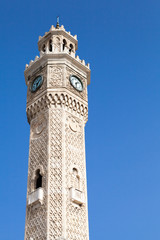 Fototapeta premium Izmir, historical clock tower over bright blue sky