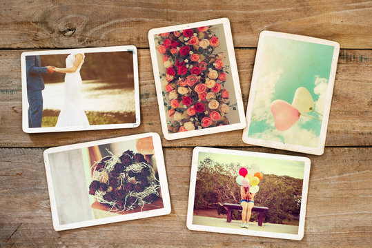 Wedding and honeymoon instans photo album on wood table. paper photo of polaroid camera - vintage and retro style