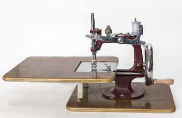 Vintage Toy Sewing Machine Box with handle isolated on white