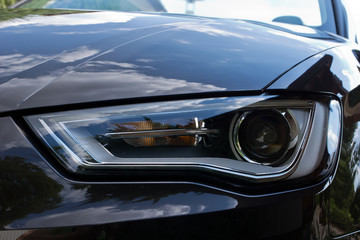 Closeup of car headlight, front view