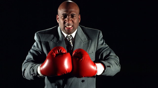 Busiessman with boxing gloves, slow motion