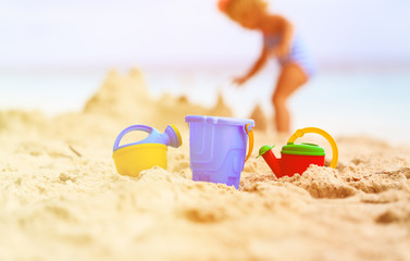kids toys and little girl building sandcastle