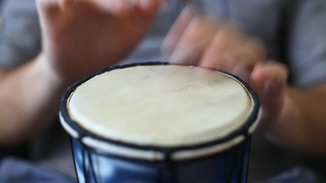 Playing Bongo drum close up HD stock footage. Hand tapping a Bongo drum in close up. 