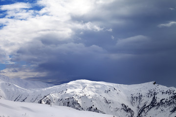 Sunlight slope and cloudy gray sky in evening