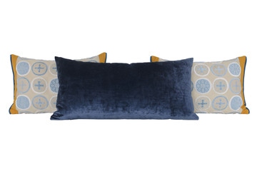 Three pillows. One blue and two beige.