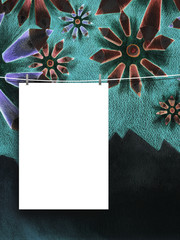 Close-up of one hanged paper sheet with pegs on flowers drawing background