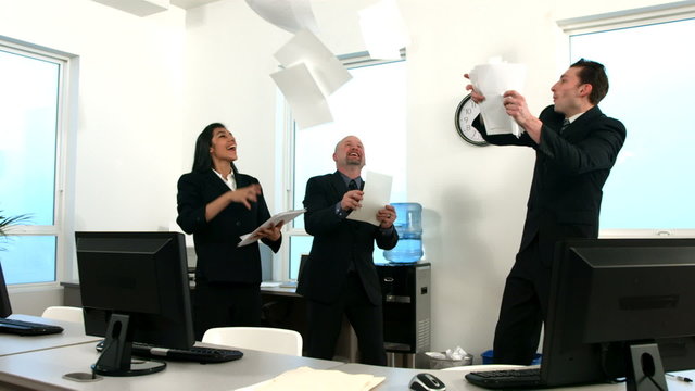 Happy businesspeople throwing papers