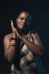 Fototapeta na wymiar Traditional xhosa woman wearing brown fabric and bracelets.
