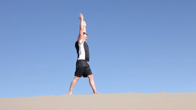 Man doing yoga in desert
