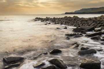 Beautiful sunset landscape image of rocky coastline in Kimmeridg