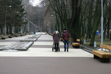 young parents walking in the park