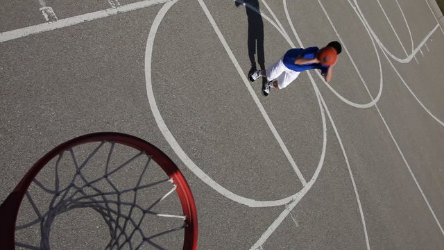 Teens shoots basketball